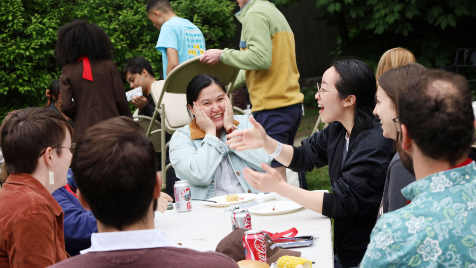 students socializing at outdoor table
