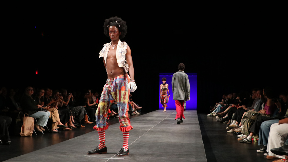 student posing on runway 