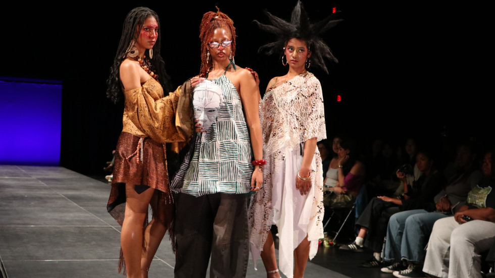 students posing on runway