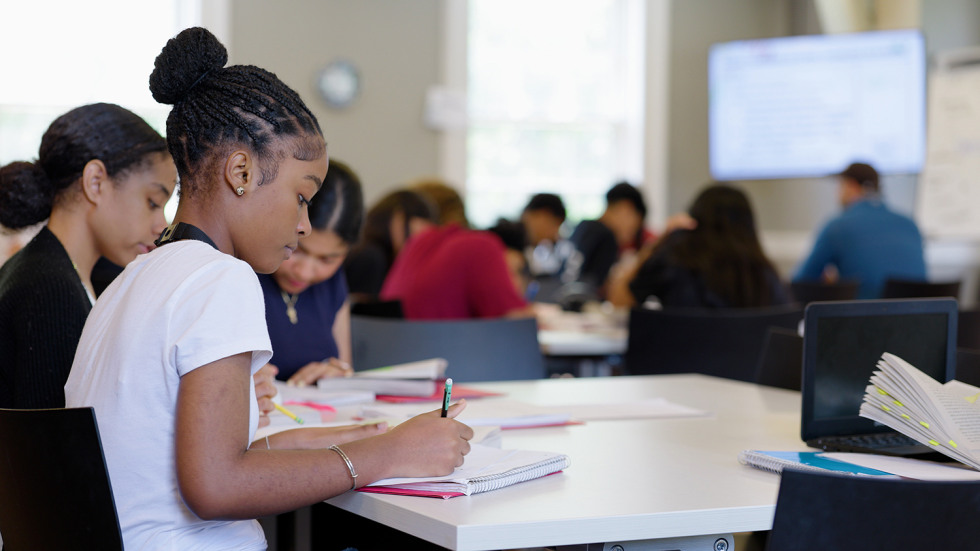 Providence students work together during the summer program of Brown Collegiate Scholars at desks with assignments. 