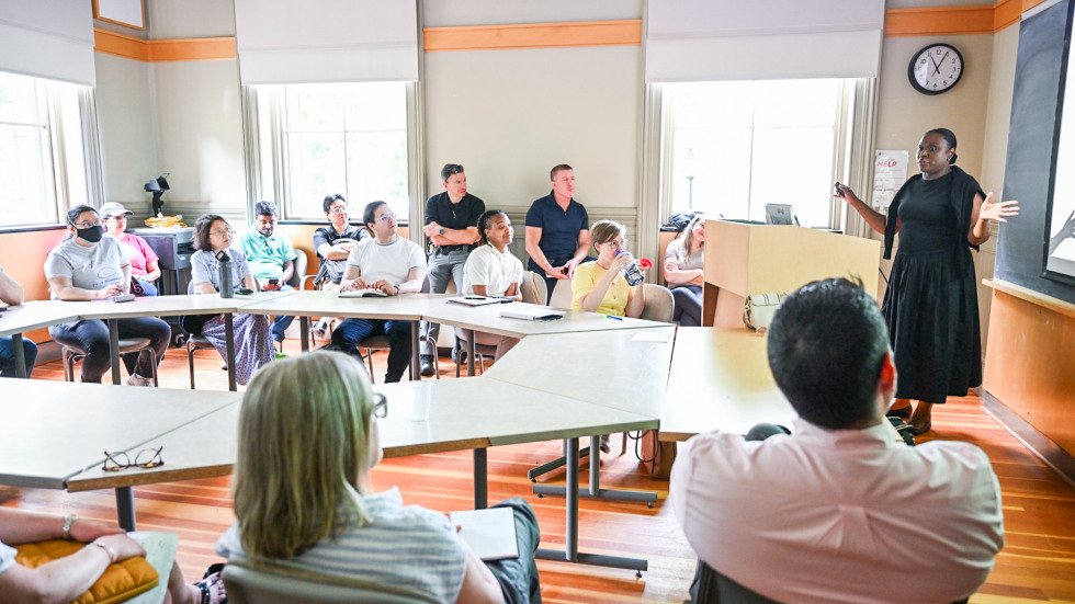 a classroom of people looking up toward the speaker