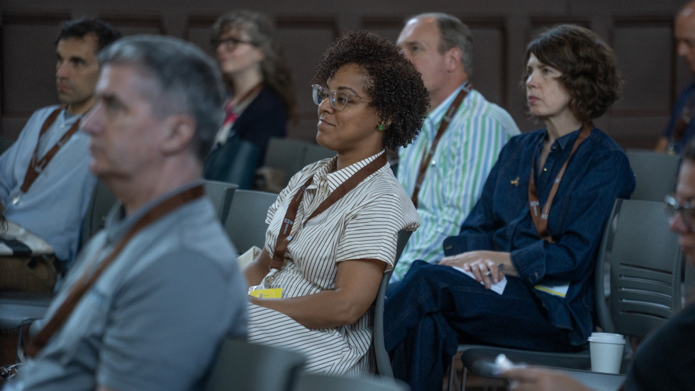 Small business owners sits in a seat in Sayles Auditorium on Brown's campus as other small businss owners shared their success winning contracts at Brown.