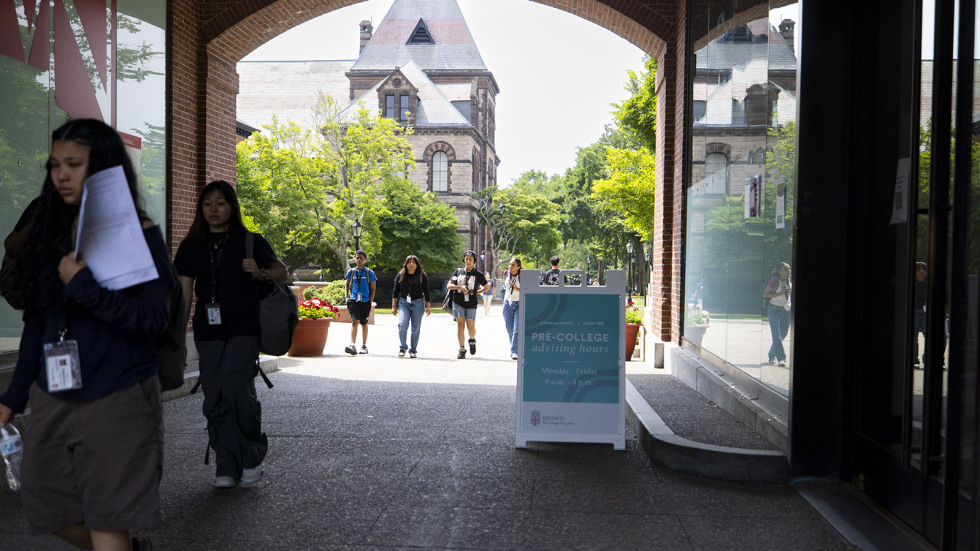 Providence teens walk through an arch near the stephen roberts campus center on Brown's campus. 