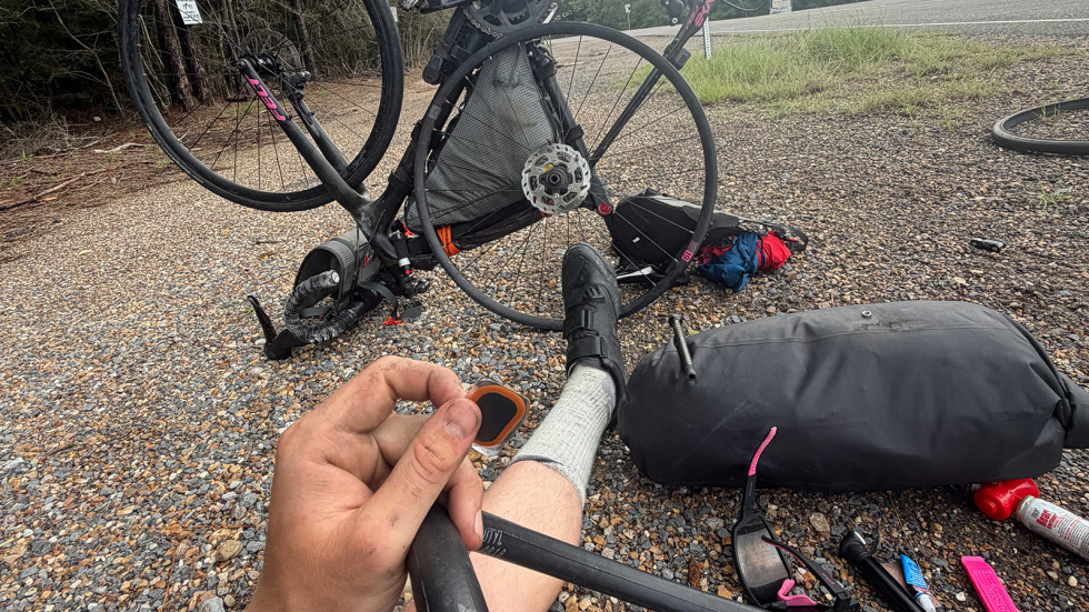Lachlan Kirby fixes a flat tire