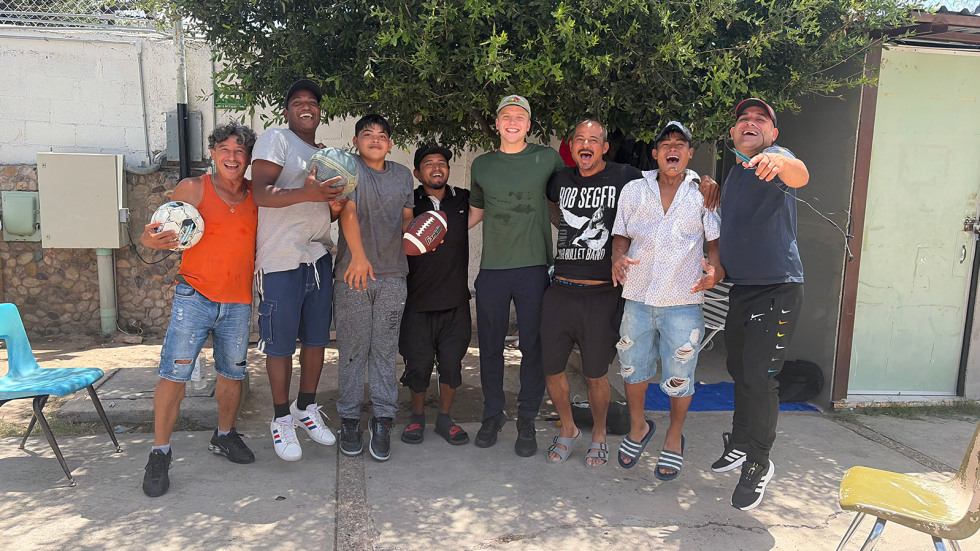 Lachlan Kirby stands with a group of new friends
