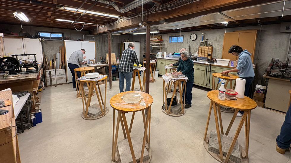 people working in an optics workshop