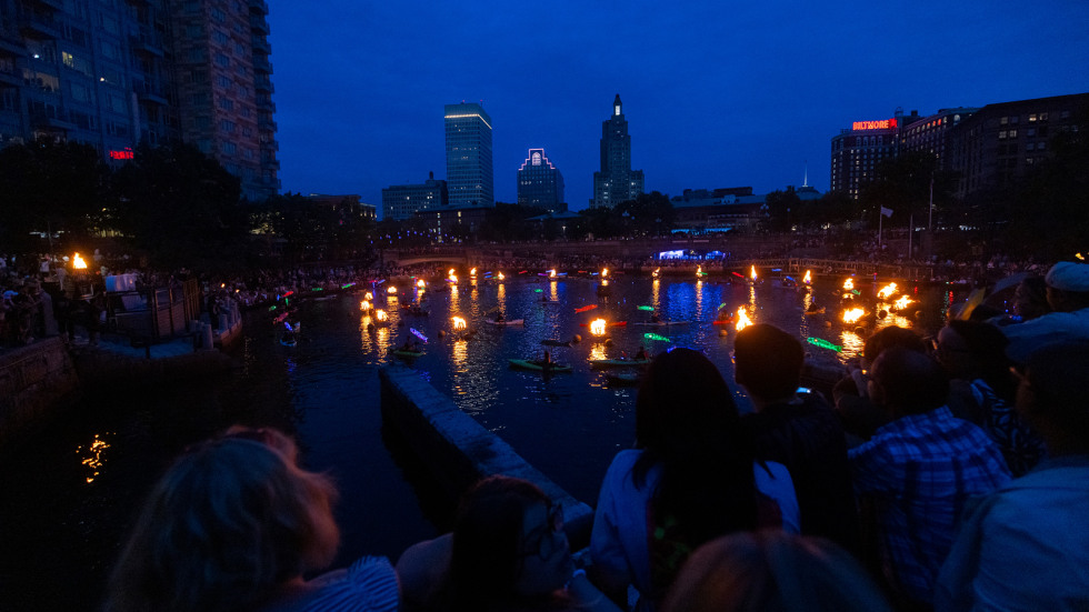 the fires glow and brighen the darkening city sky. 