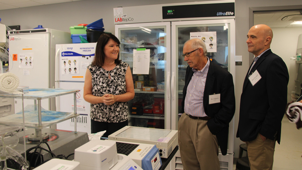 two commissioners in Jill Kreiling's lab at Brown
