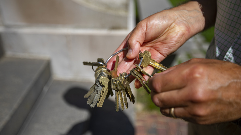 A facilities worker searches among dozens of keys to open a campus building. 