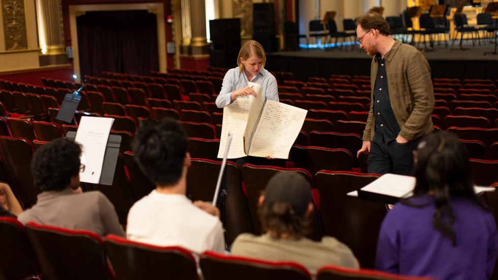 Conductor looking at musical composition 