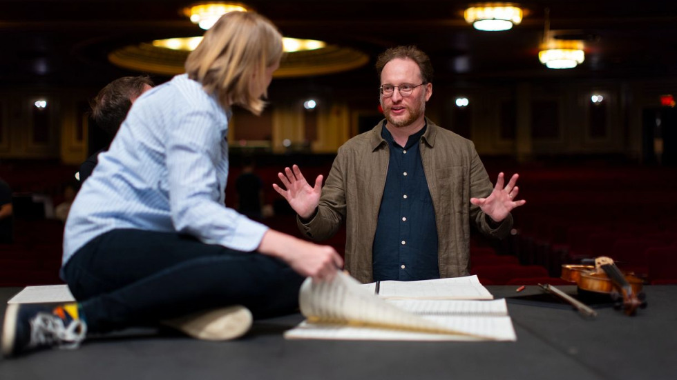 RI Philharmonic conductor speaking with composer about his work