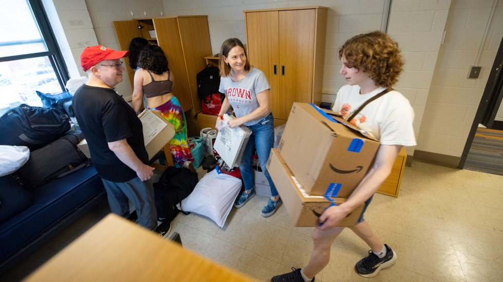 Lily D'Ordine moves boxes into her room 