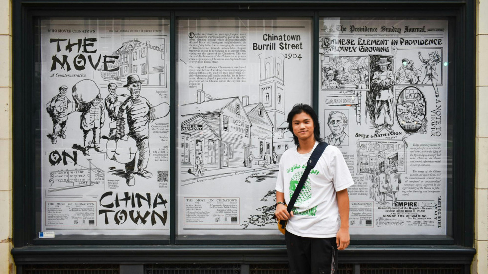 Aidan Choi standing in front of his artwork 