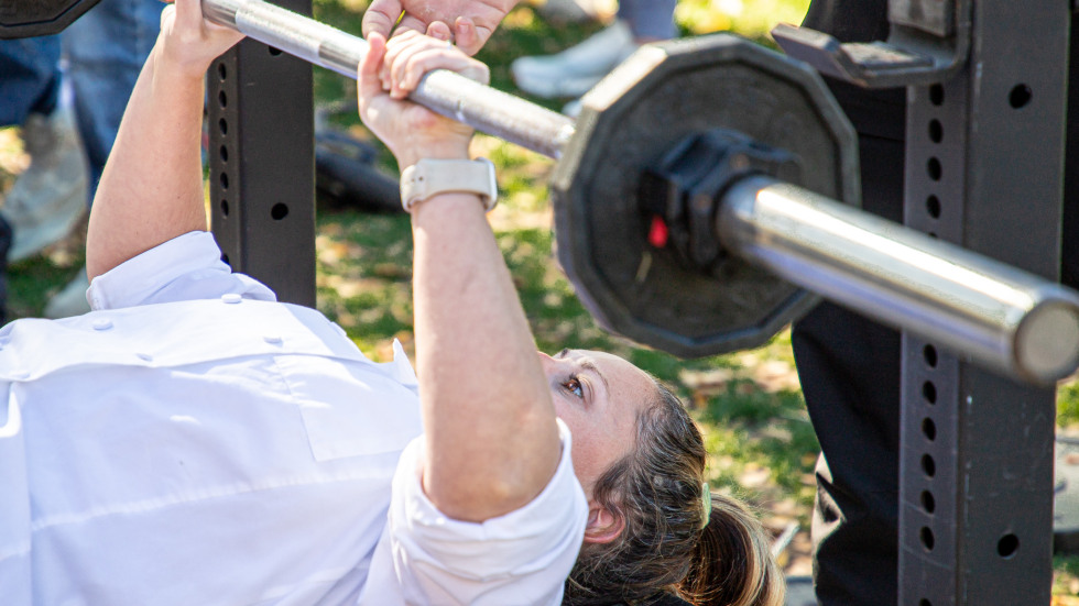 a students readies to push weight on a bench press