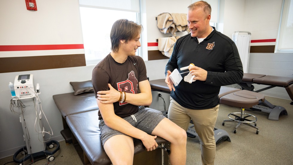 Matt Whalen works with a student in the sports medicine room 
