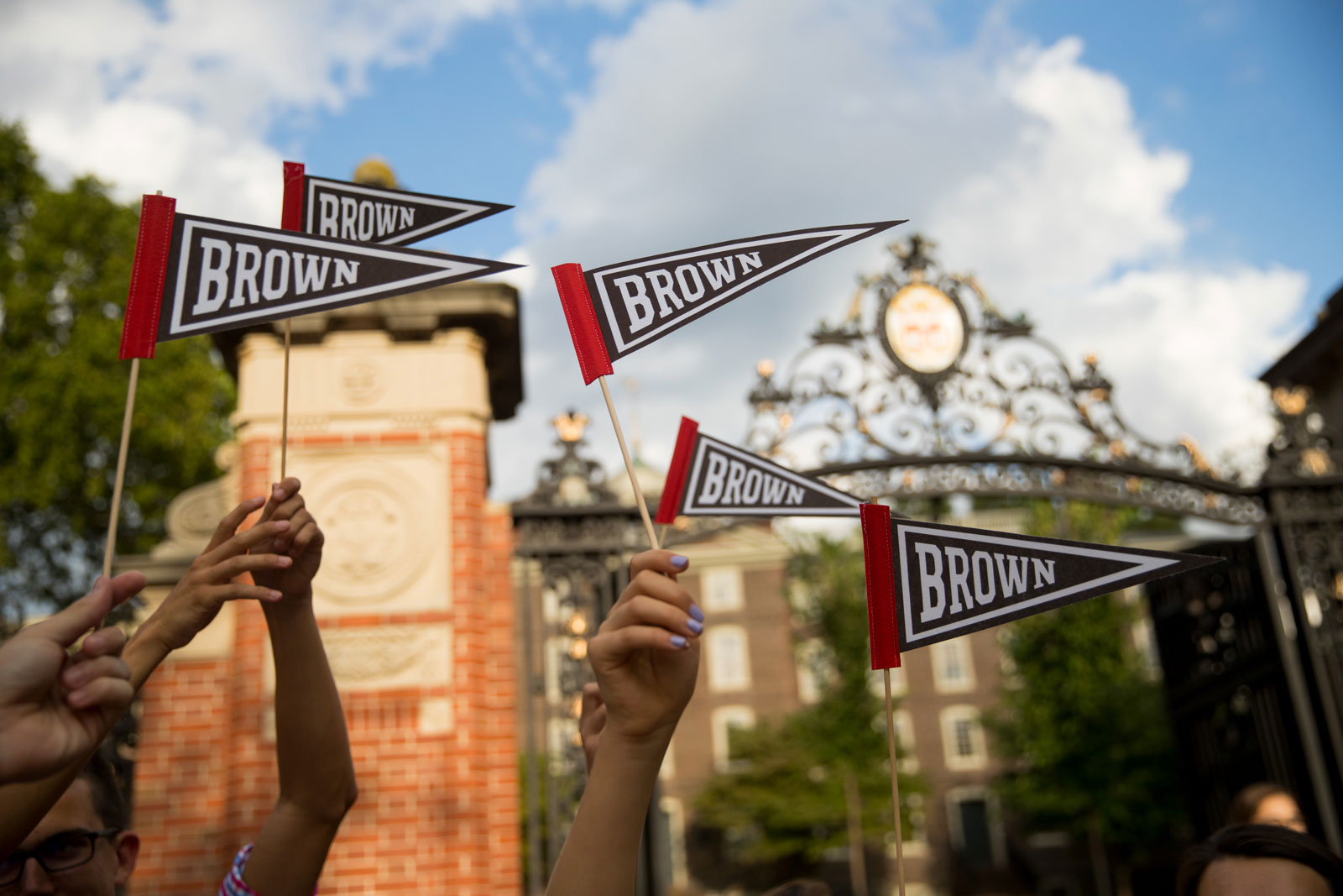 Students wave Brown flags in front of Van Wickle Gates