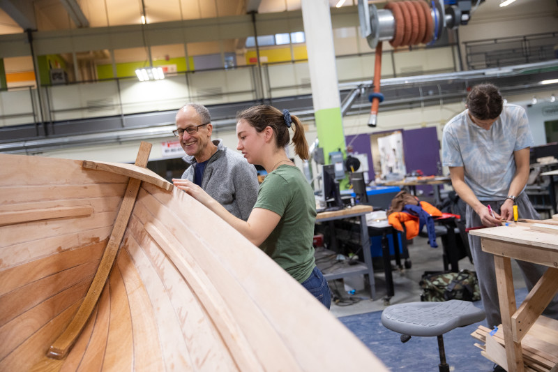 Image of people building a boat