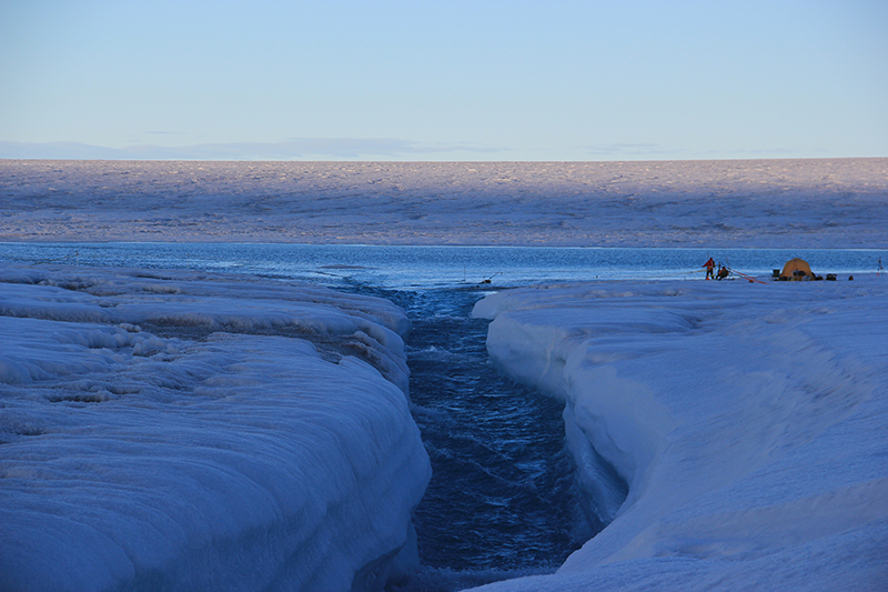 Image of a stream running atop a glacer