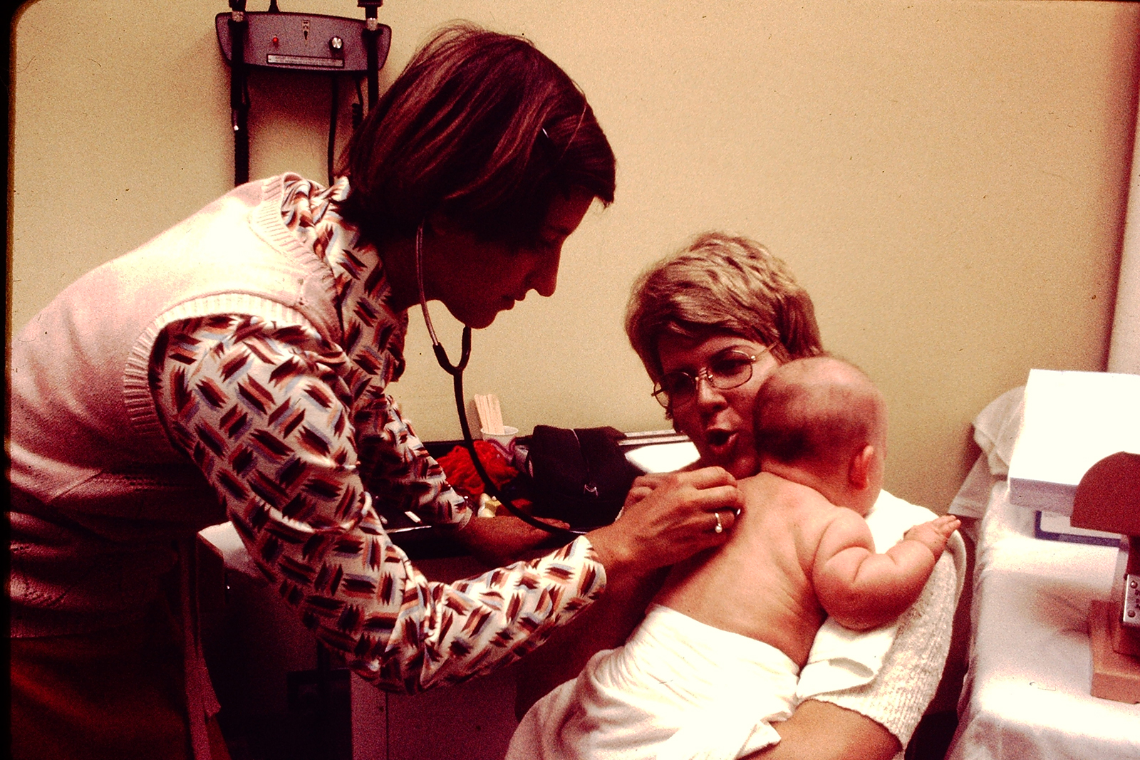 Medical student listens to baby's breathing