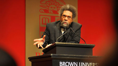 Cornel West speaking at a podium at Brown University