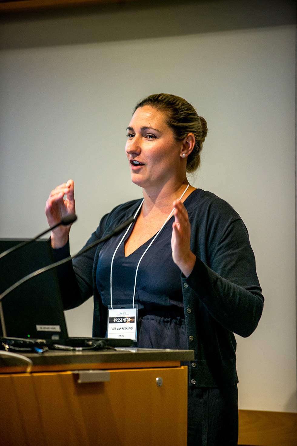 Eliza Van Reen speaking at a podium