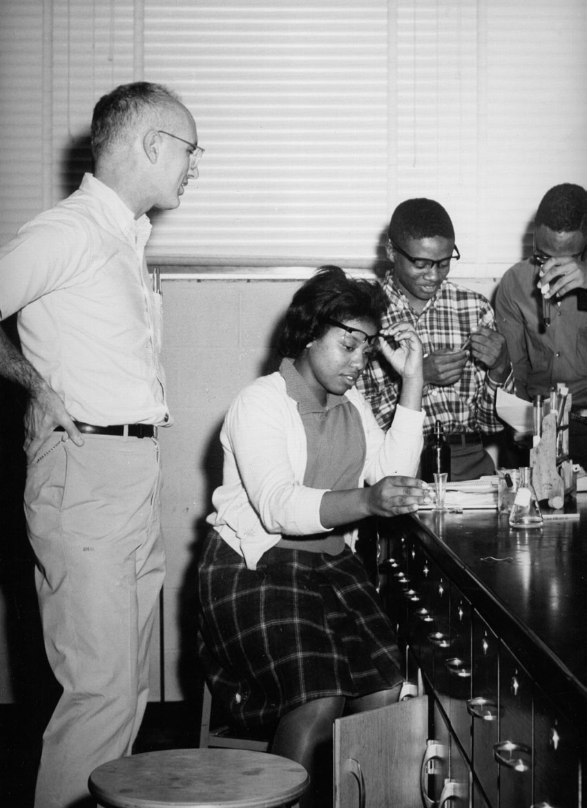 Professor teaching students in a chemistry lab