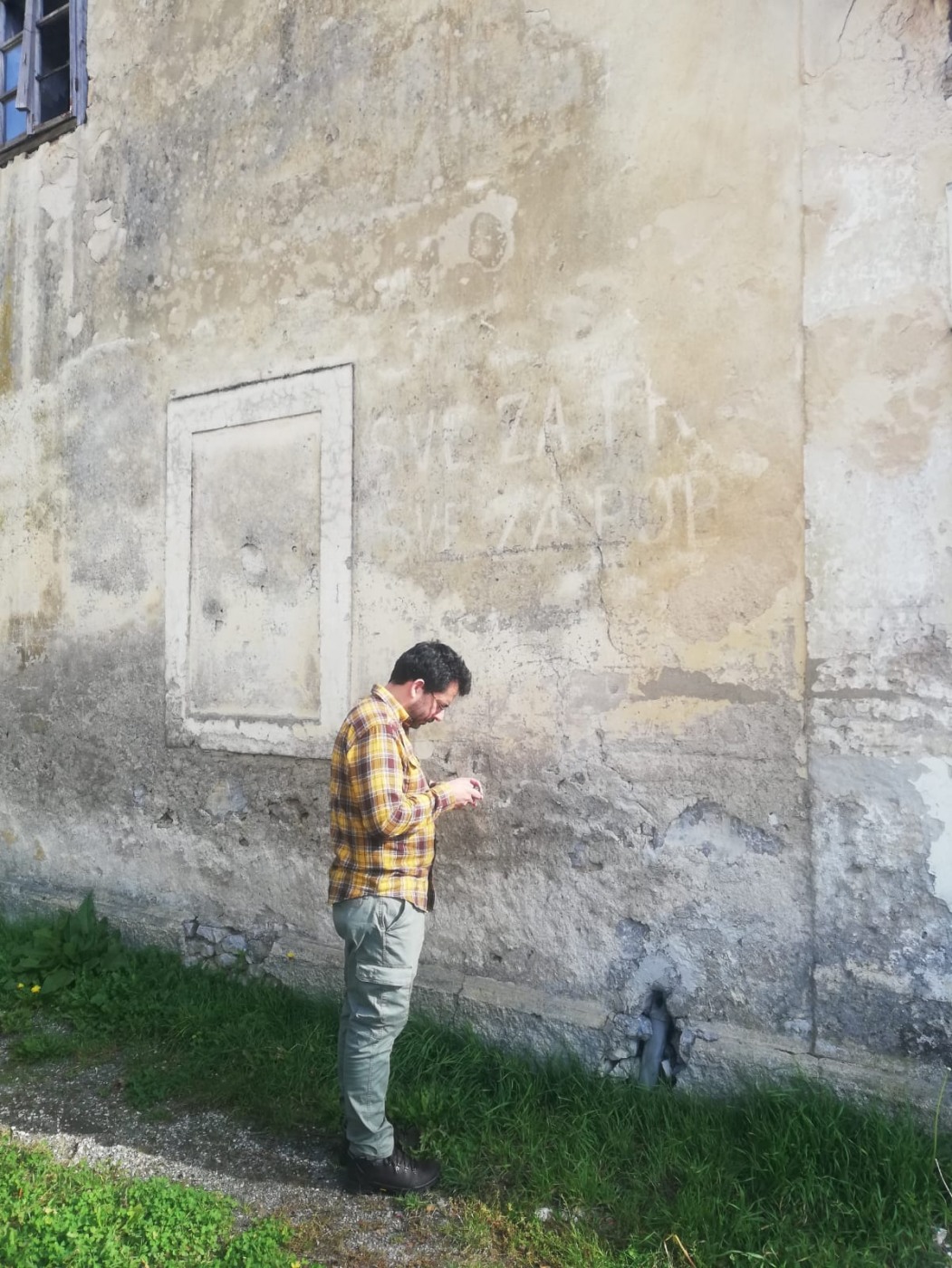 man stands in front of wall