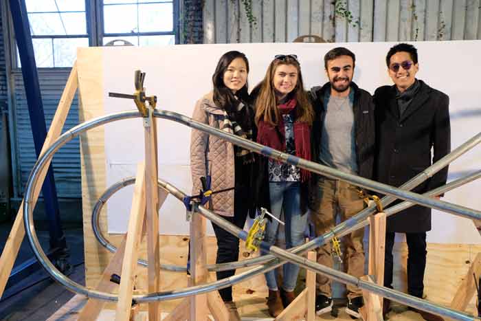Students pose with sundial while under construction