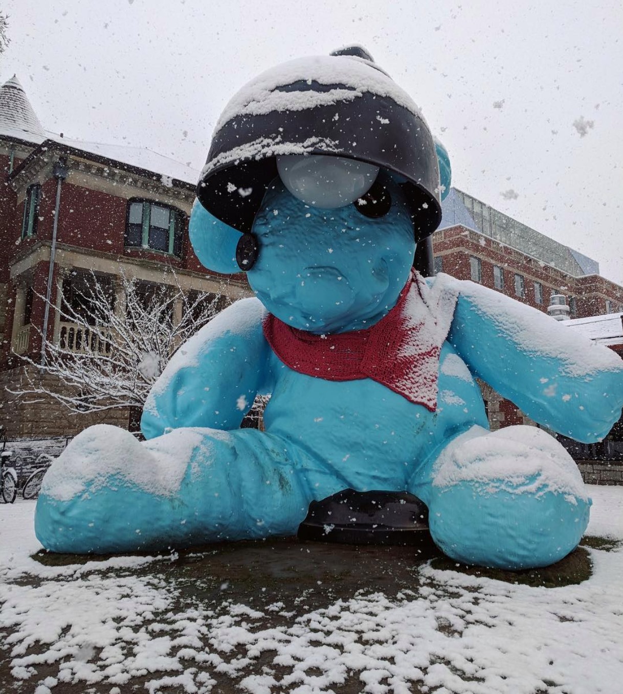 Blue bear sculpture wearing an orange scarf