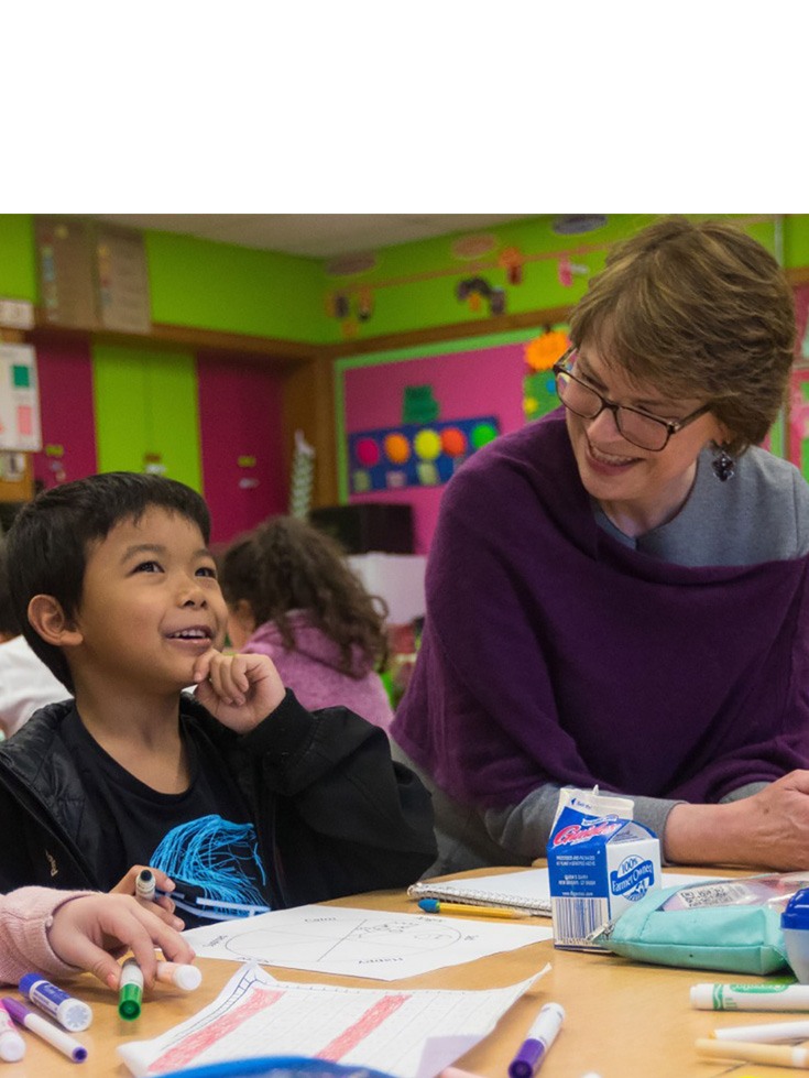 Christina Paxson interacting with a child at D'Abate Elementary School