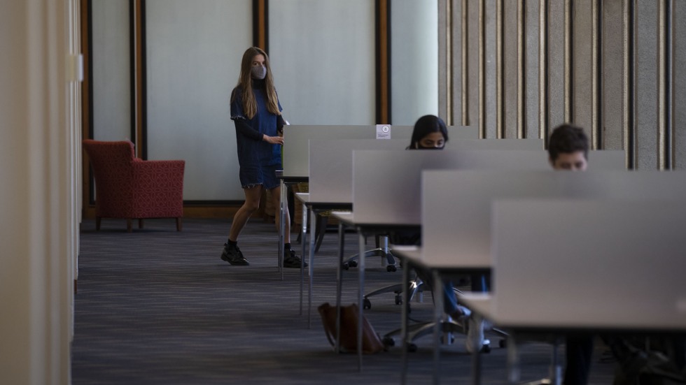 Students study in socially-distanced cubicles at the Rockefeller Library at Brown University