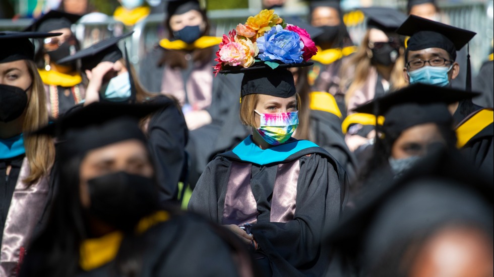 woman wearing mortarboard hat covered in flowers