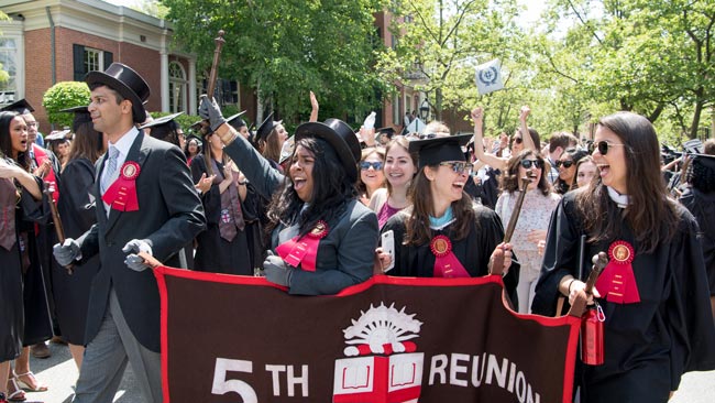 alums holding reunion banner