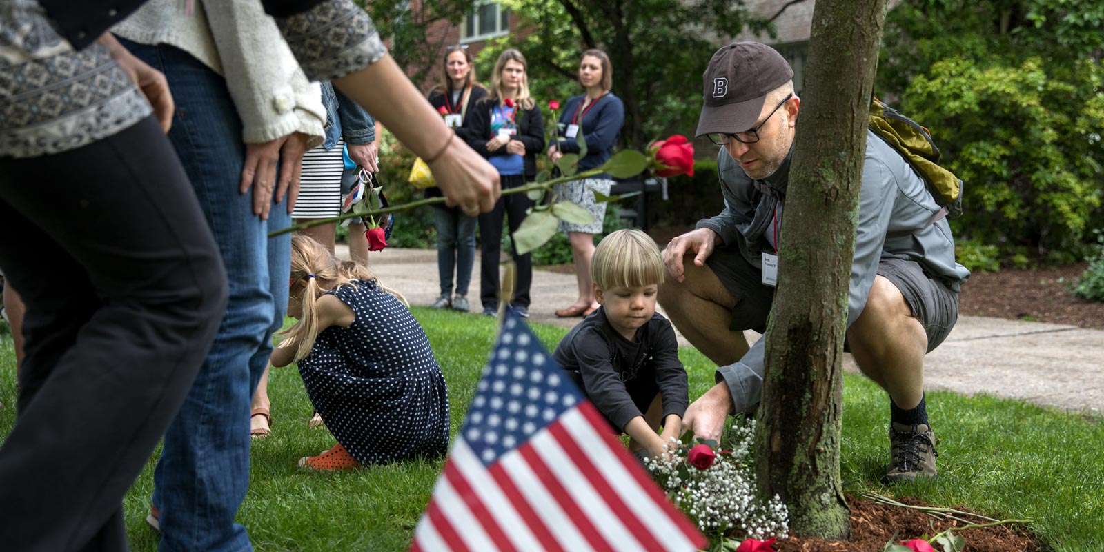 During a Saturday ceremony in Patriots Court, Brown alumnus Seth Toomay and his son, Gavin, placed flowers in memory of Brown alumni killed in the 9/11 attacks.