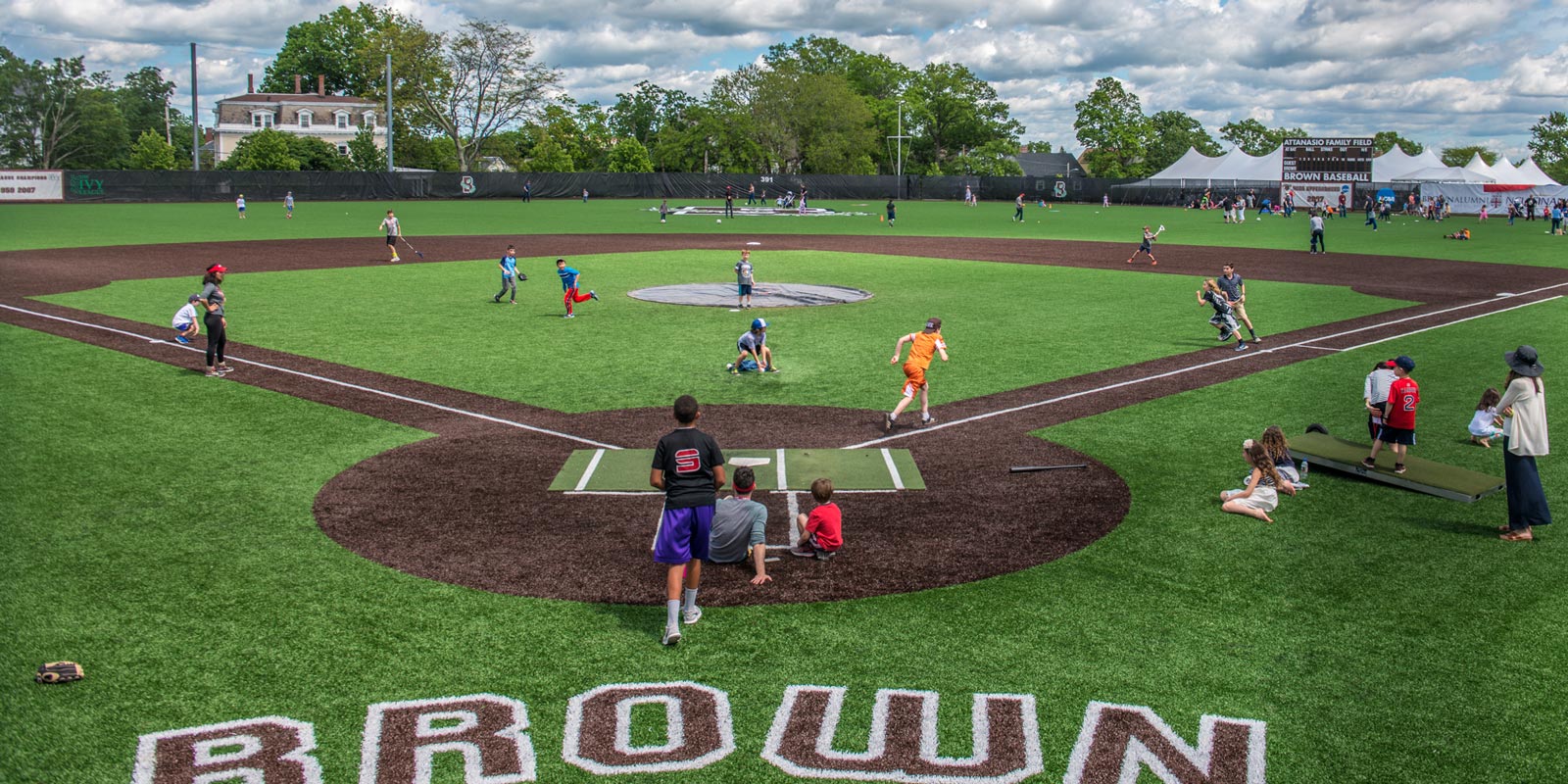 It's a hit! Alumni and families gathered on Brown's baseball field for some Field Day action.