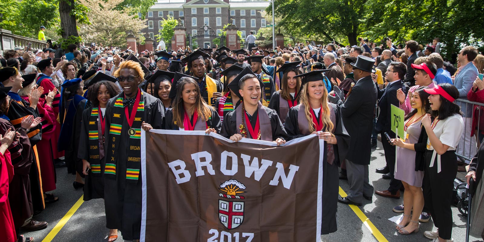 Banner-carrying marshals Marques Love, Lehidy Frias, Viet Nguyen and Julia Schoenewald led the undergraduate Class of 2017's procession down College Street.
