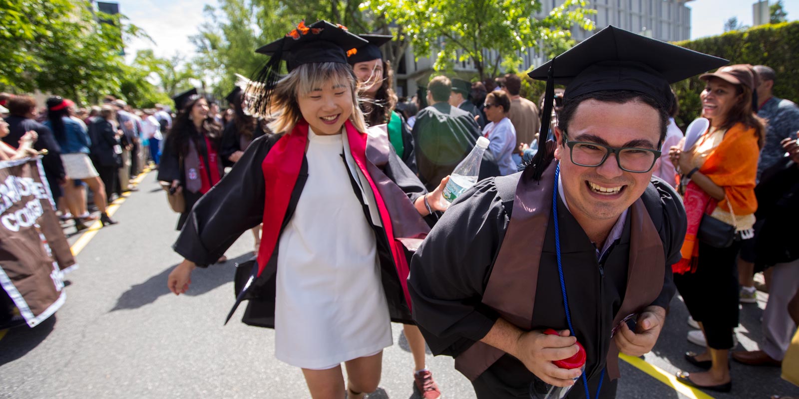 Graduates Katherine Hsu and Paul Martino made their way down College Street with energy, enthusiasm and excitement.