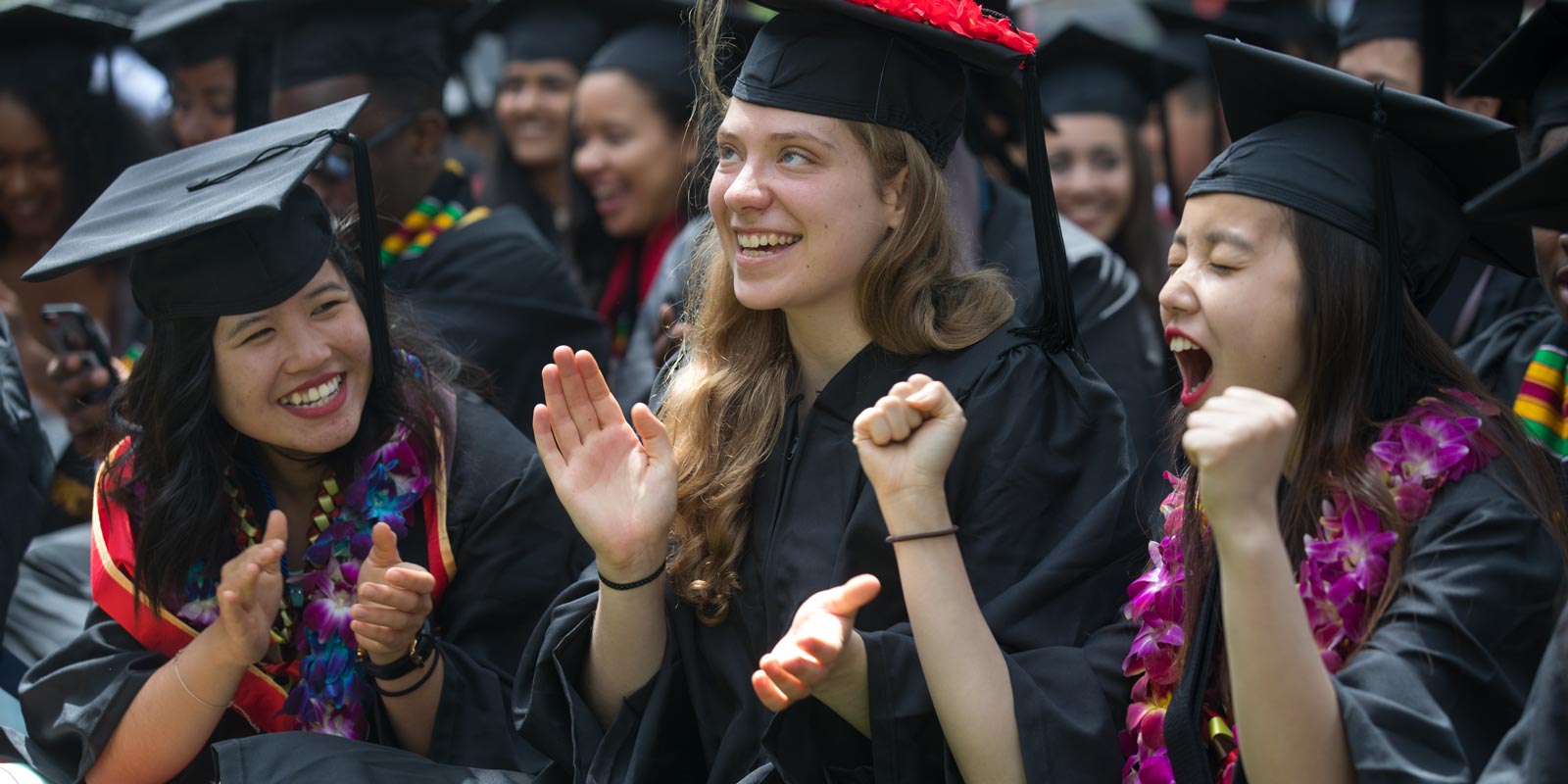 Marisa Vang (right) let out a cheer after President Paxson formally conferred degrees upon her, Nancy Truong, Cynthia Hale-Phillips and the rest of the graduating class at the College Ceremony.