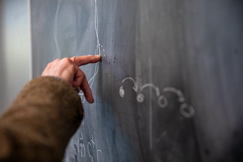Image of Manfred Steiner pointed at a blackboard